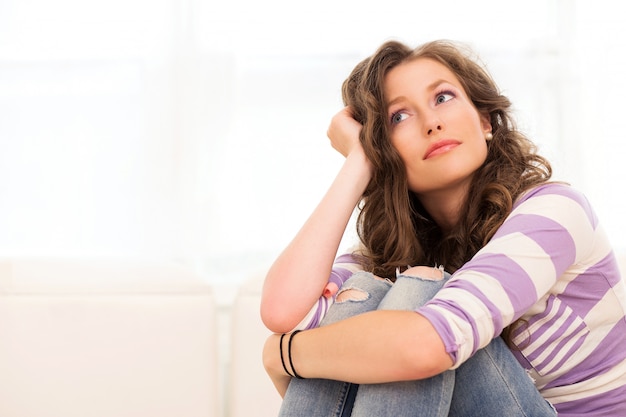 Free photo thinking beautiful women, sitting on the sofa