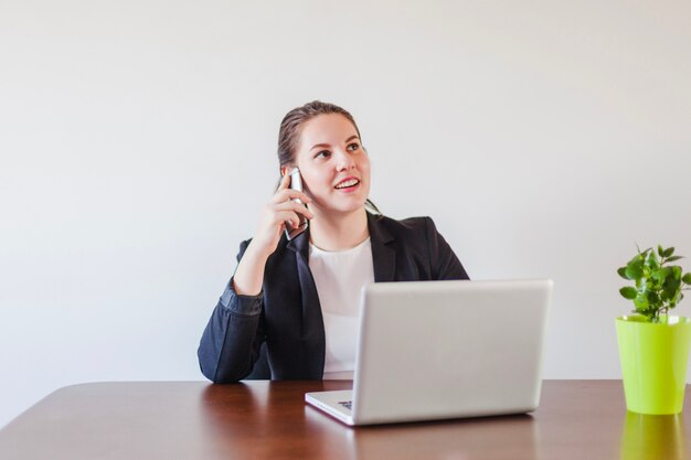 Free photo thinking woman conversating with phone