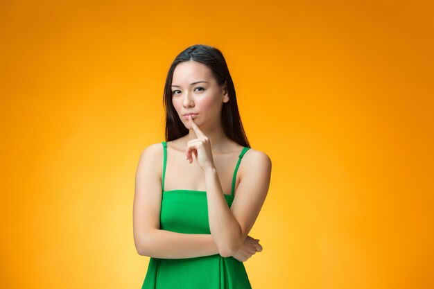Thinking woman in green dress