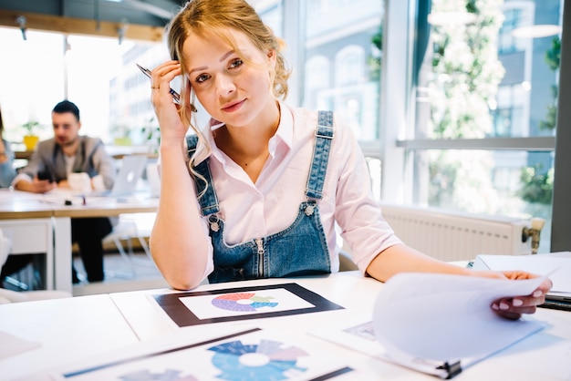 Thinking woman with papers