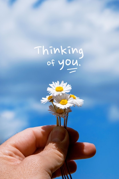 Free photo thinking of you text over image of hand holding flowers