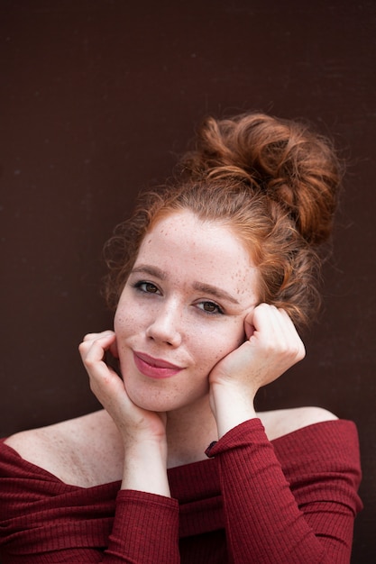 Thinking young woman looking at camera