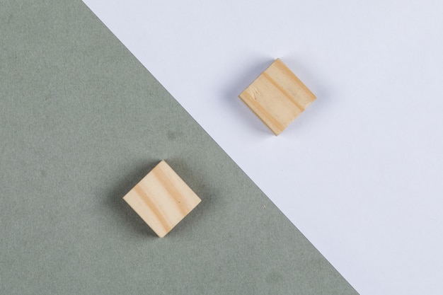 Free photo thought difference concept with wooden blocks on navy green and white background top view. horizontal image