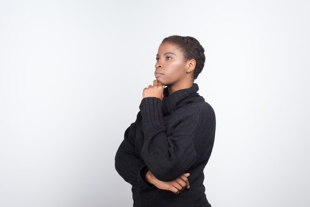 Thoughtful African American woman holding hand on chin