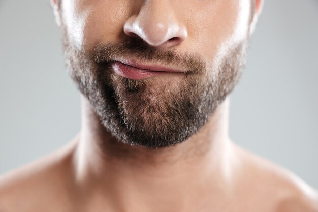 Thoughtful bearded mans face isolated