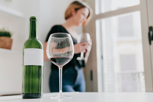 Thoughtful blurred woman drinking wine