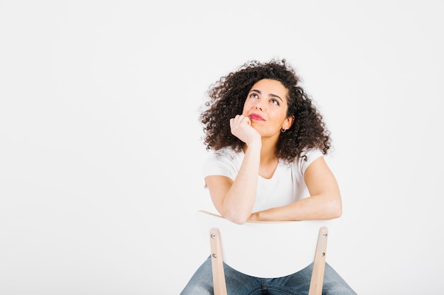 Thoughtful brunette on chair