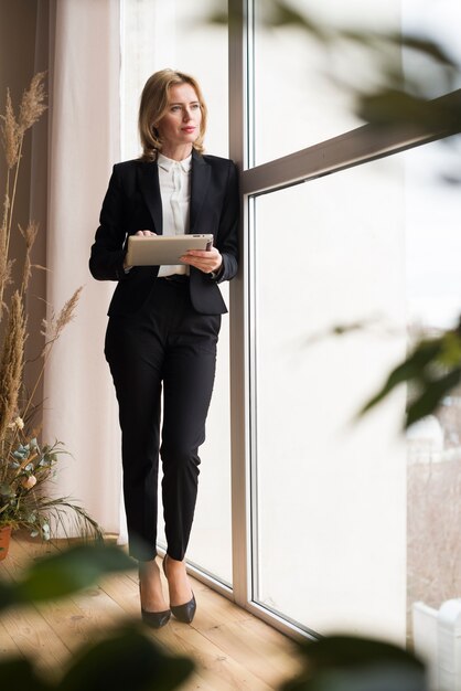 Thoughtful business woman using tablet