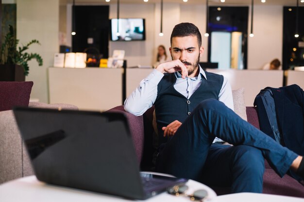 Free photo thoughtful businessman with gadgets