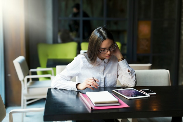 Thoughtful businesswoman sitting in cafe