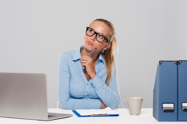 Thoughtful businesswoman sitting at office