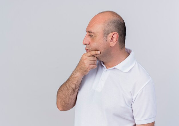 Thoughtful casual mature businessman putting hand on chin looking straight isolated on white background with copy space