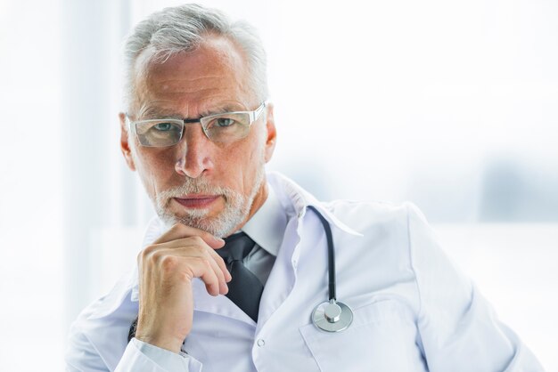 Thoughtful doctor looking at camera