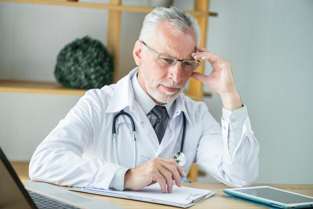 Thoughtful doctor making notes
