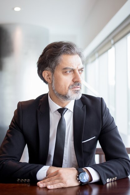 Thoughtful Entrepreneur Sitting at Empty Desk