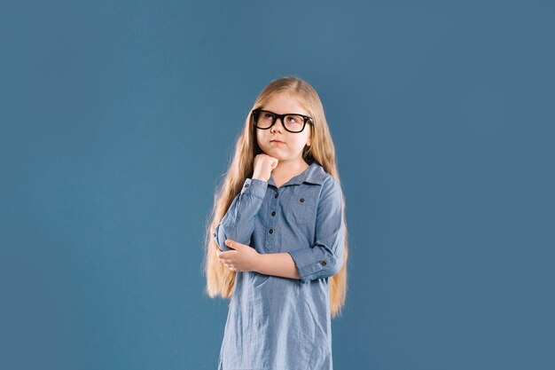 Thoughtful girl in glasses