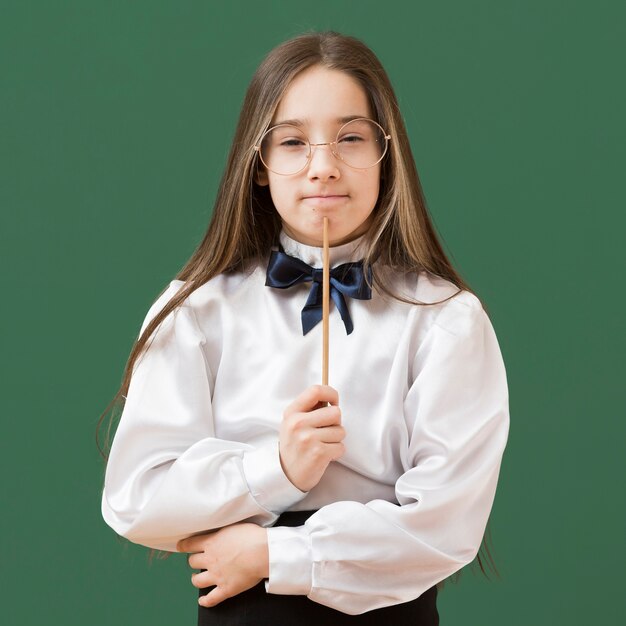 Thoughtful girl holding stick close up