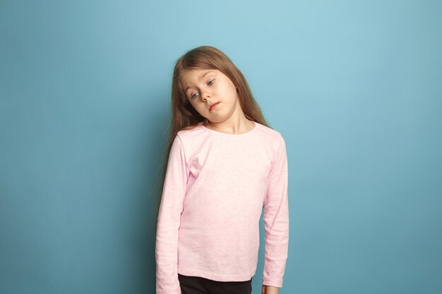 thoughtful girl. sad teen girl on blue. Facial expressions and people emotions concept