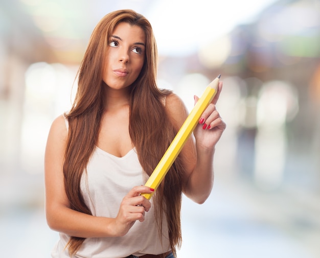 Thoughtful girl with pencil