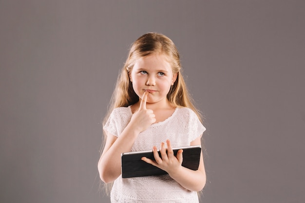 Free photo thoughtful girl with tablet