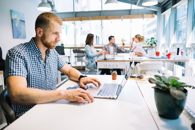 Thoughtful man at laptop in office