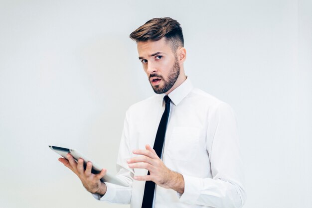 Thoughtful man looking at a tablet