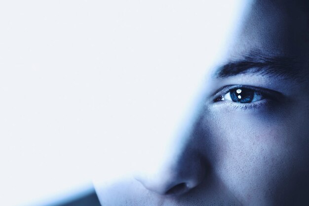 Thoughtful man looking through glass background business vision