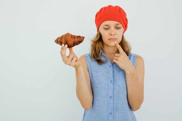 Thoughtful Nice Woman Holding Delicious Croissant