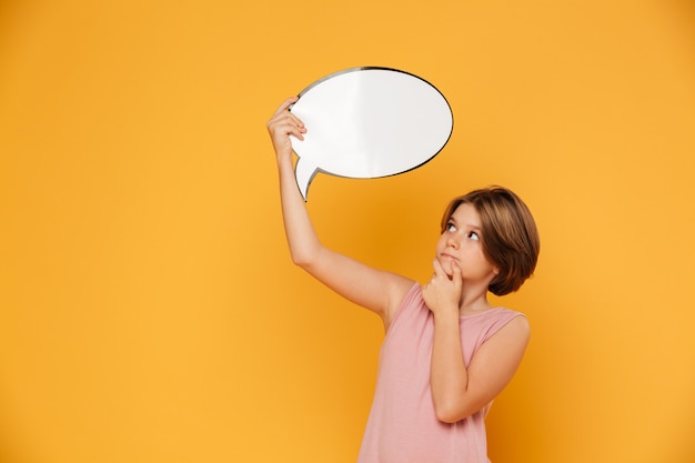 Thoughtful serious girl holding bubble speech over head isolated