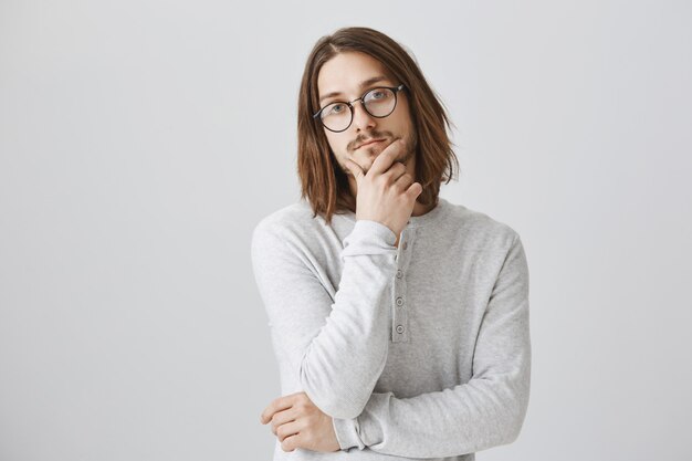 Thoughtful serious man thinking, wear glasses, making decision