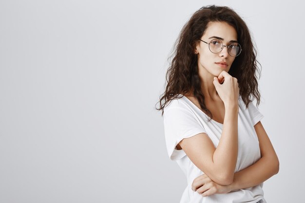 Thoughtful smart girl in glasses looking, thinking