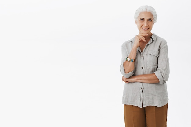 Thoughtful smiling grandmother looking, making choice