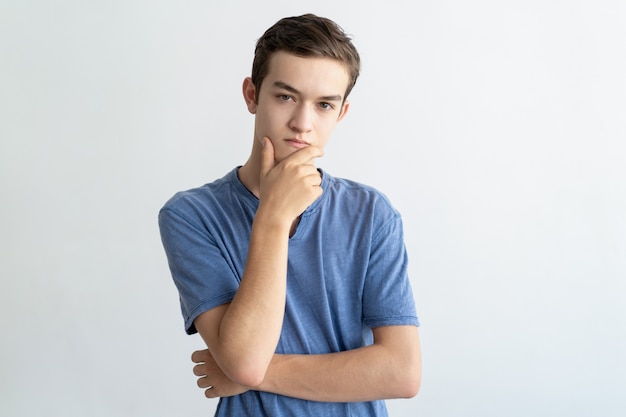 Thoughtful teenage guy thinking over problem