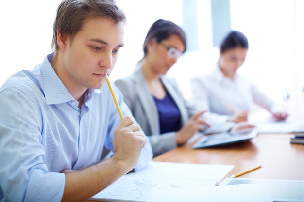 Thoughtful teenage with students in background