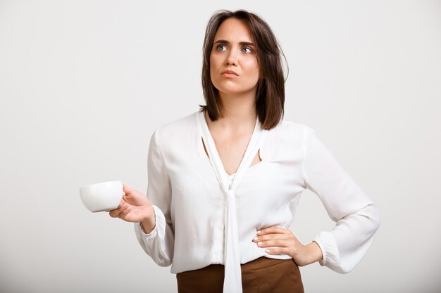 Thoughtful upset fashion woman drink coffee, thinking