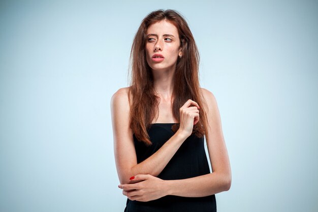 The thoughtful woman on gray background