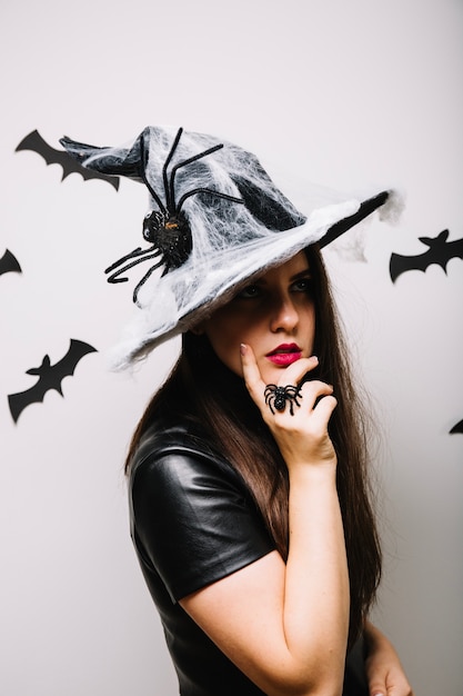 Thoughtful woman in Halloween hat