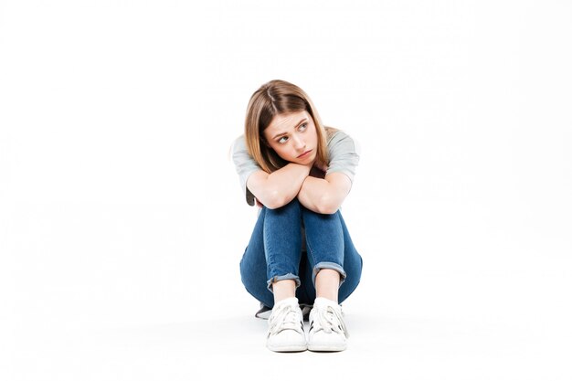 thoughtful woman sitting cross-legged