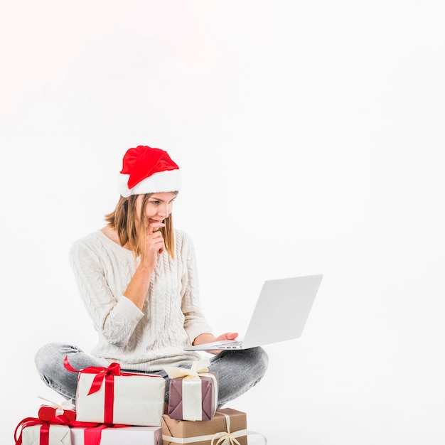 Thoughtful woman sitting with laptop