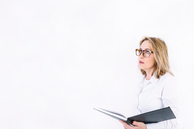 Thoughtful woman with notebook