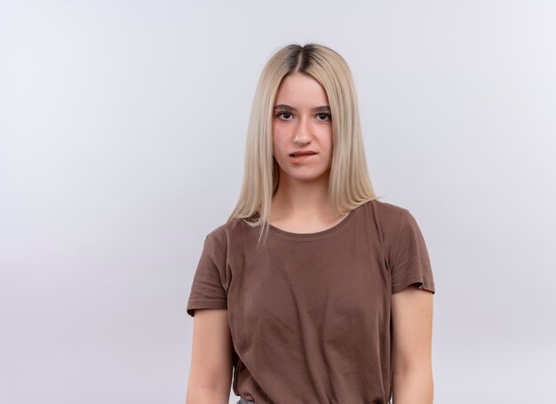 Thoughtful young blonde girl biting her lip standing on isolated white wall with copy space