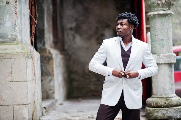 Thoughtful young handsome african american gentleman in formalwear Black stylish model man in white jacket