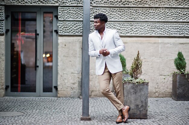 Thoughtful young handsome african american gentleman in formalwear Black stylish model man in white jacket