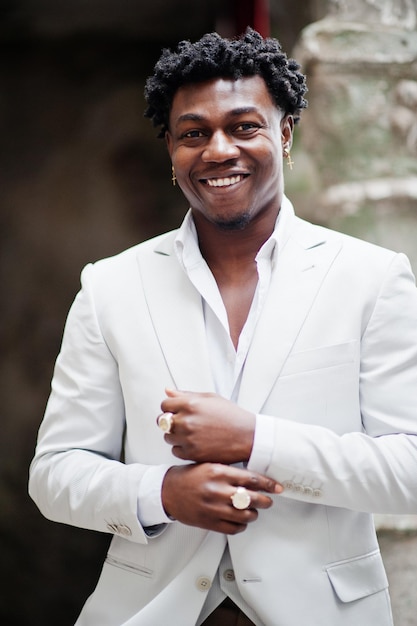 Thoughtful young handsome african american gentleman in formalwear Black stylish model man in white jacket