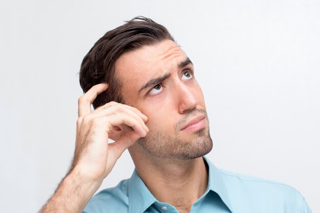 Thoughtful Young Handsome Man Scratching Head