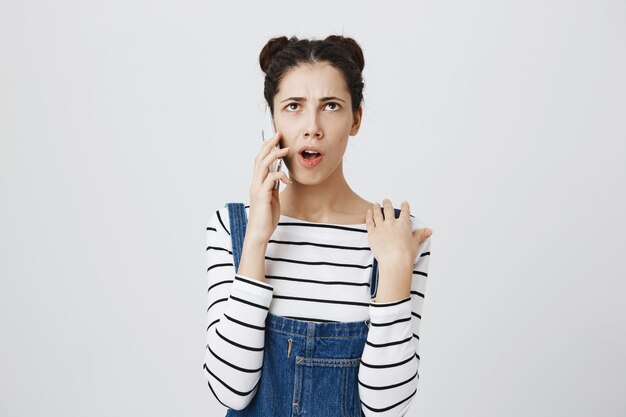 Thoughtful young woman have phone conversation