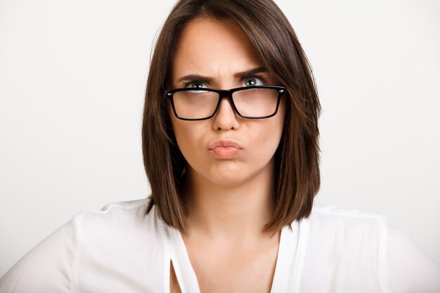 Thoughtful young woman pondering how solve problem