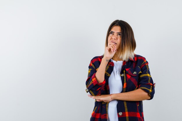 Thoughtful young woman on white background