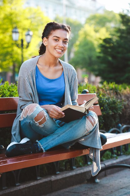 Thouhtful beautiful african girl reading the book