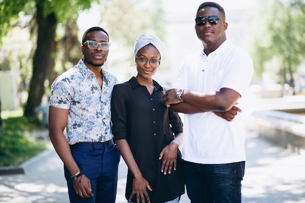 Three afican american people talking in the street